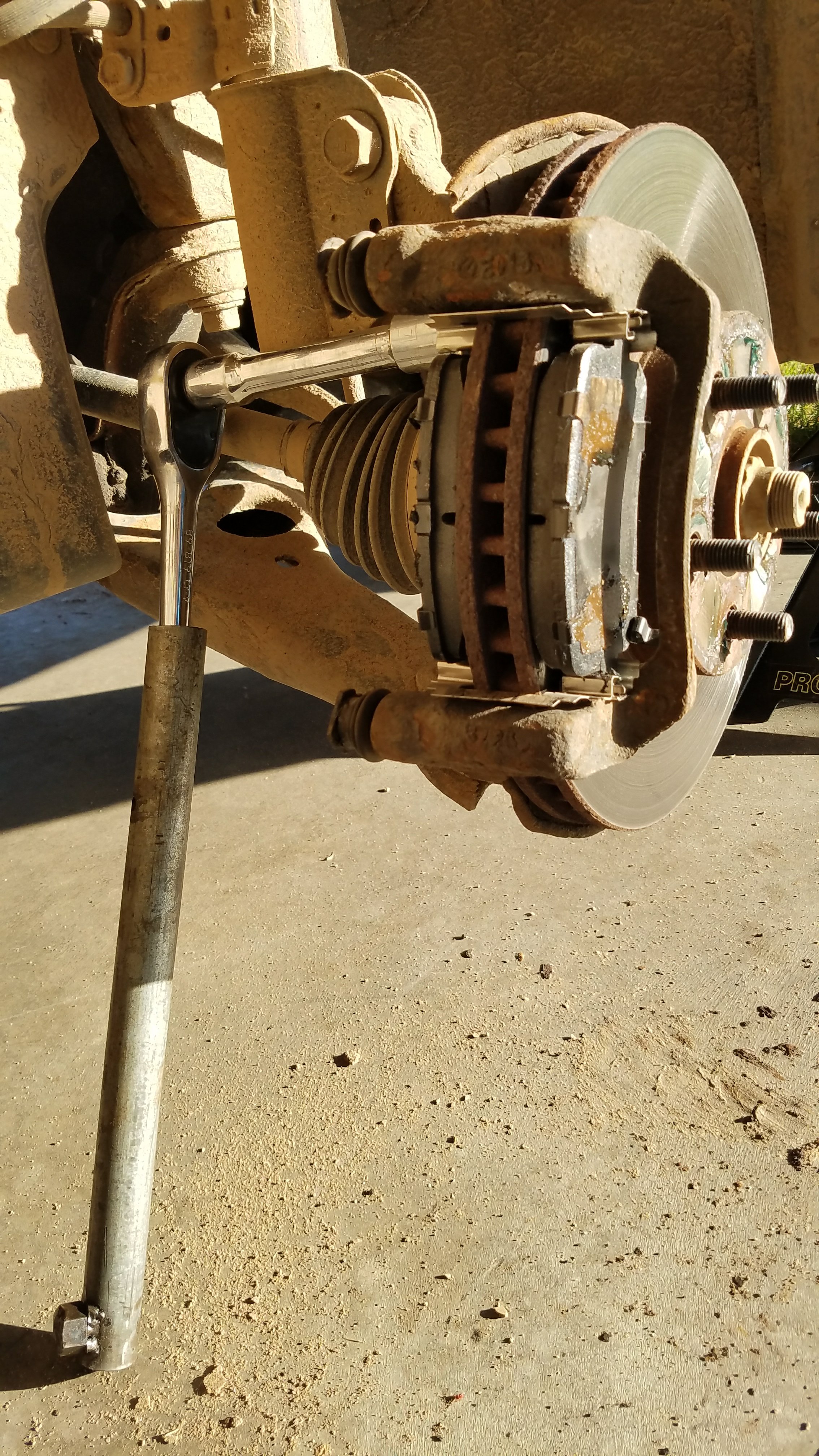 Remove the top caliper bracket bolt