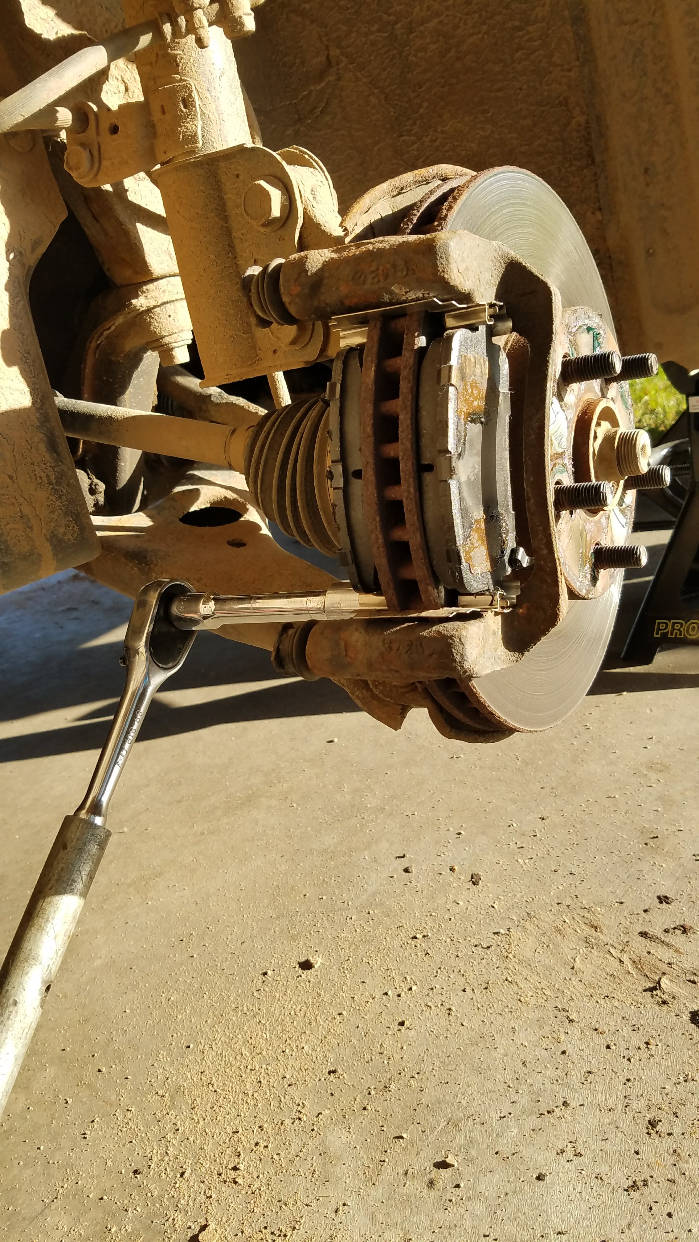 Remove the bottom caliper bracket bolt.