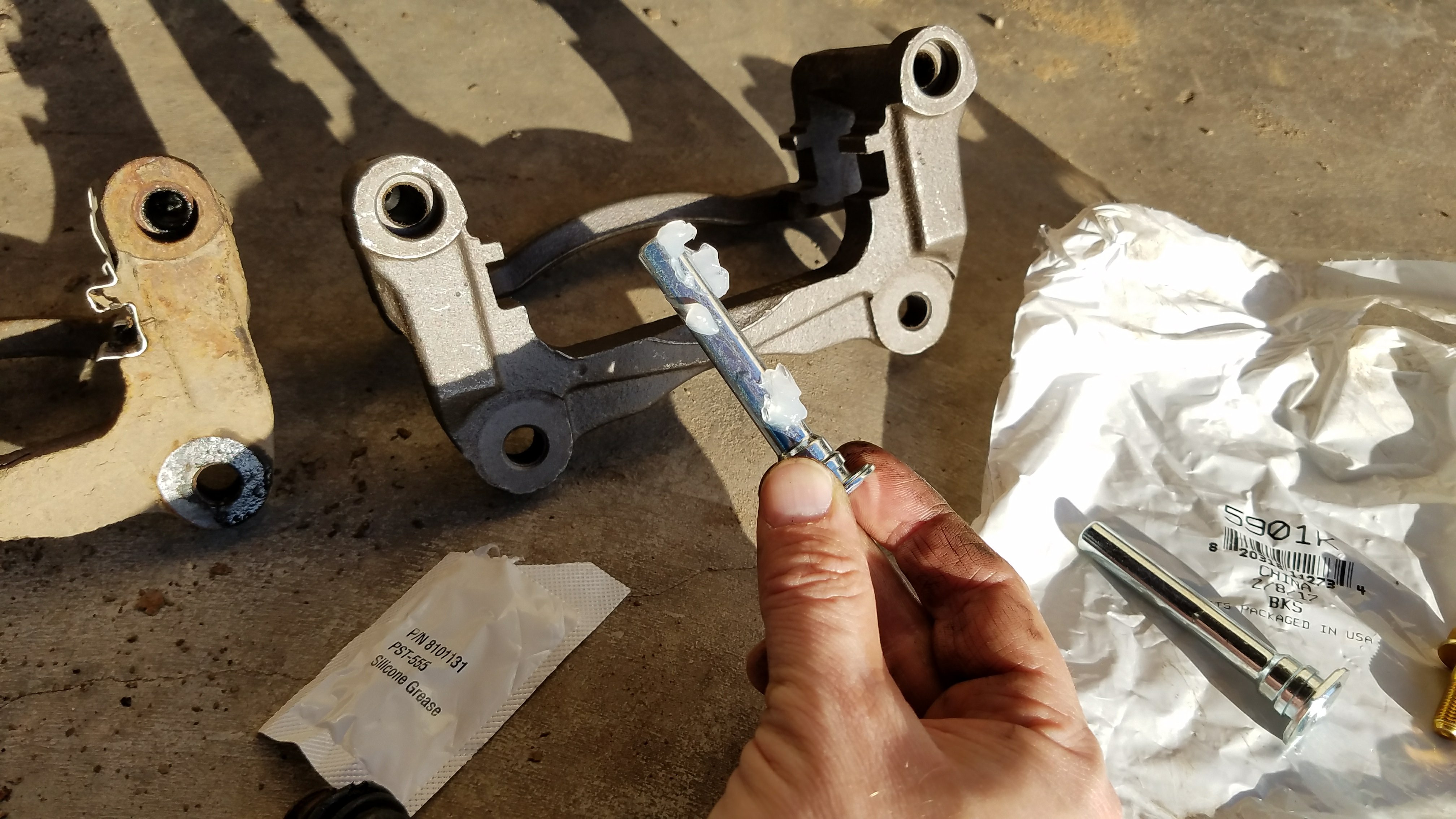 Put grease on the caliper pin.