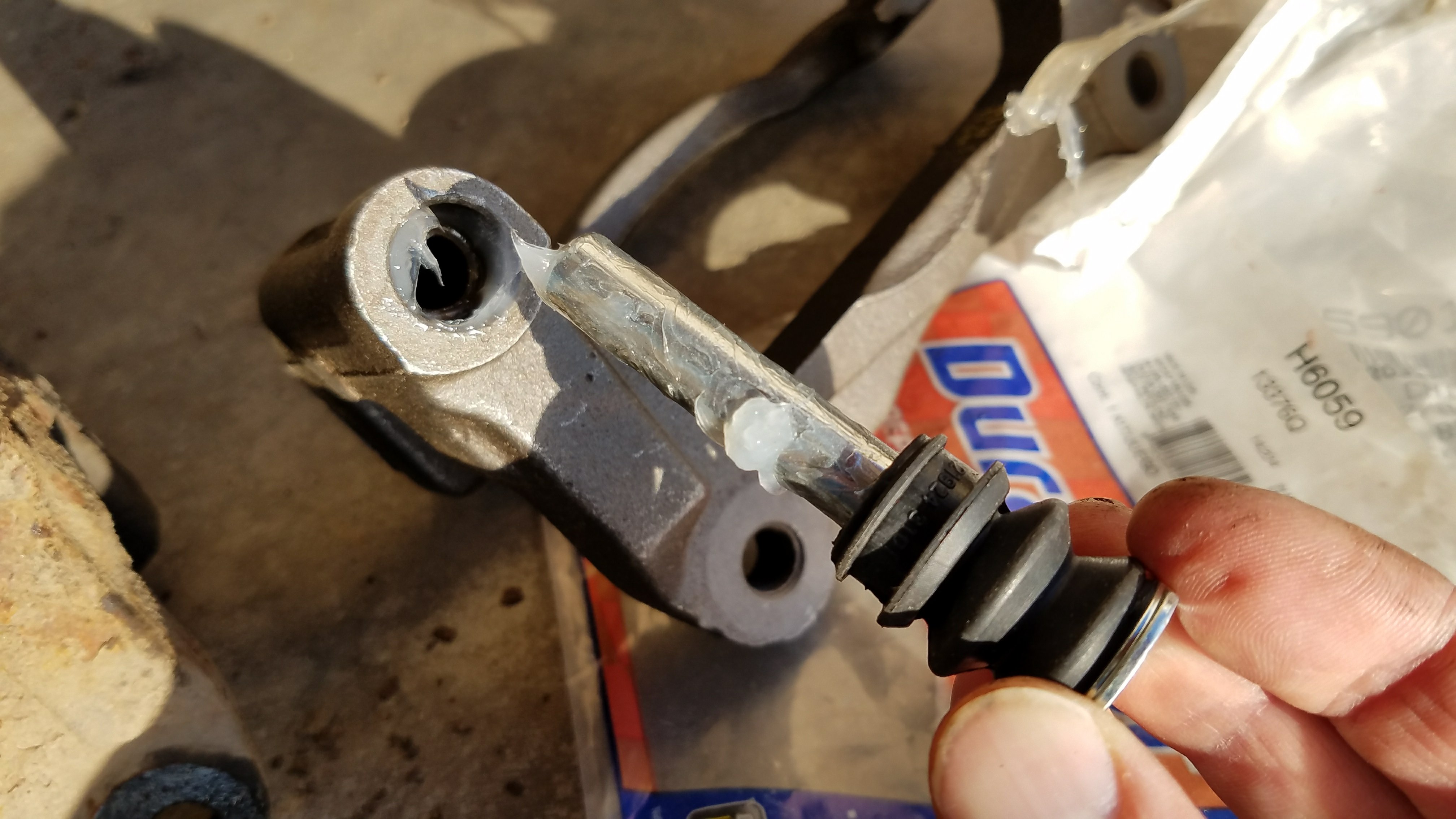 Put grease on the caliper pin and inside the boot.