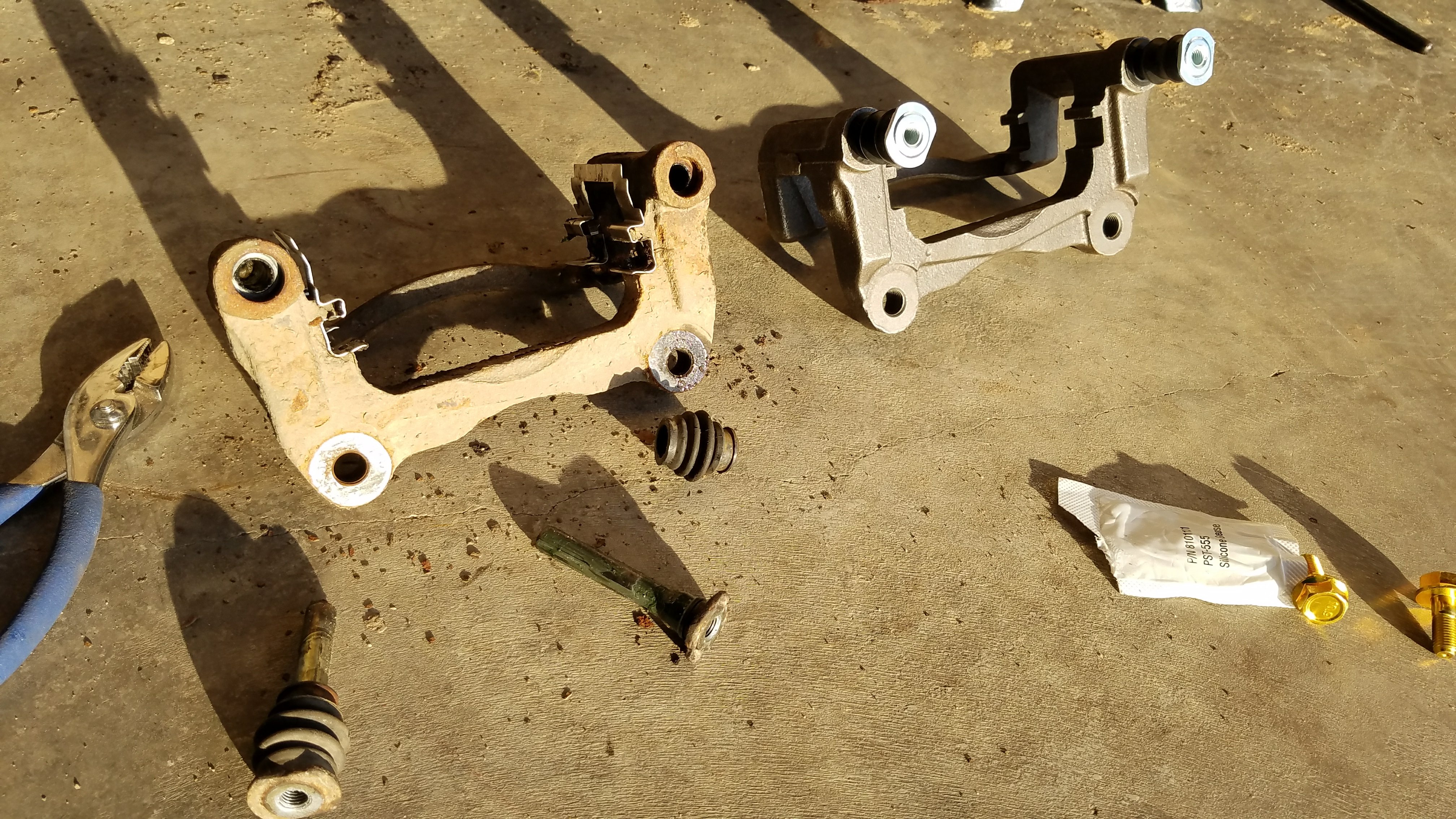 old and new caliper brackets