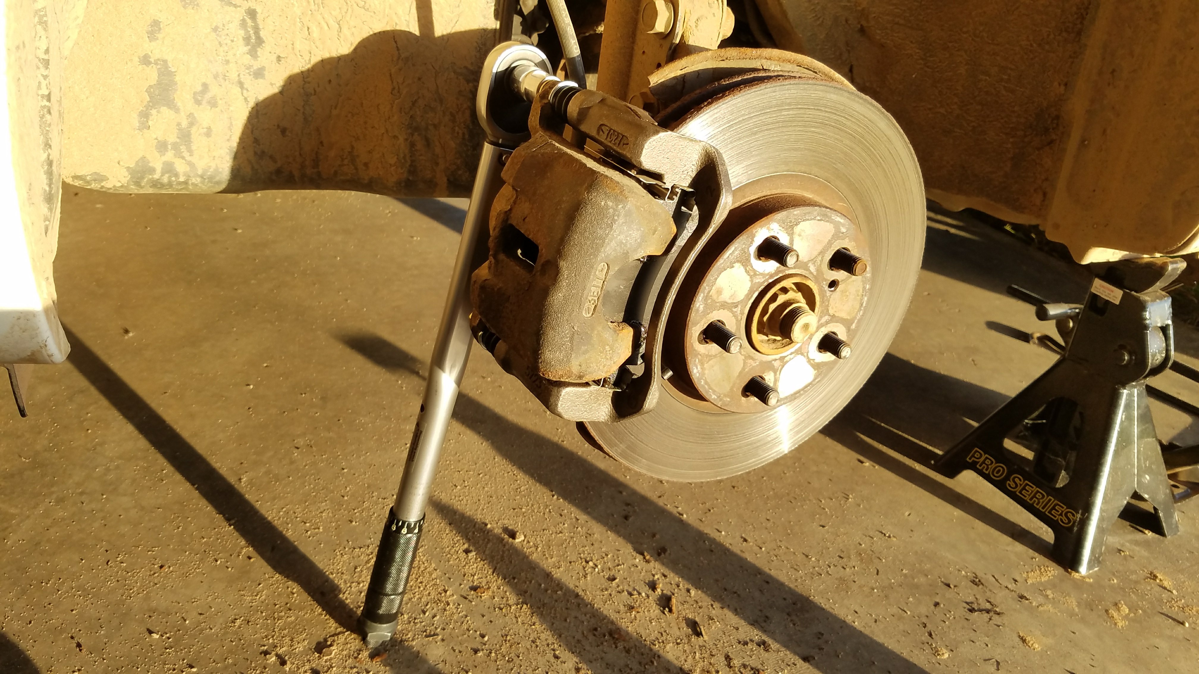 Torque the caliper bracket bolts.