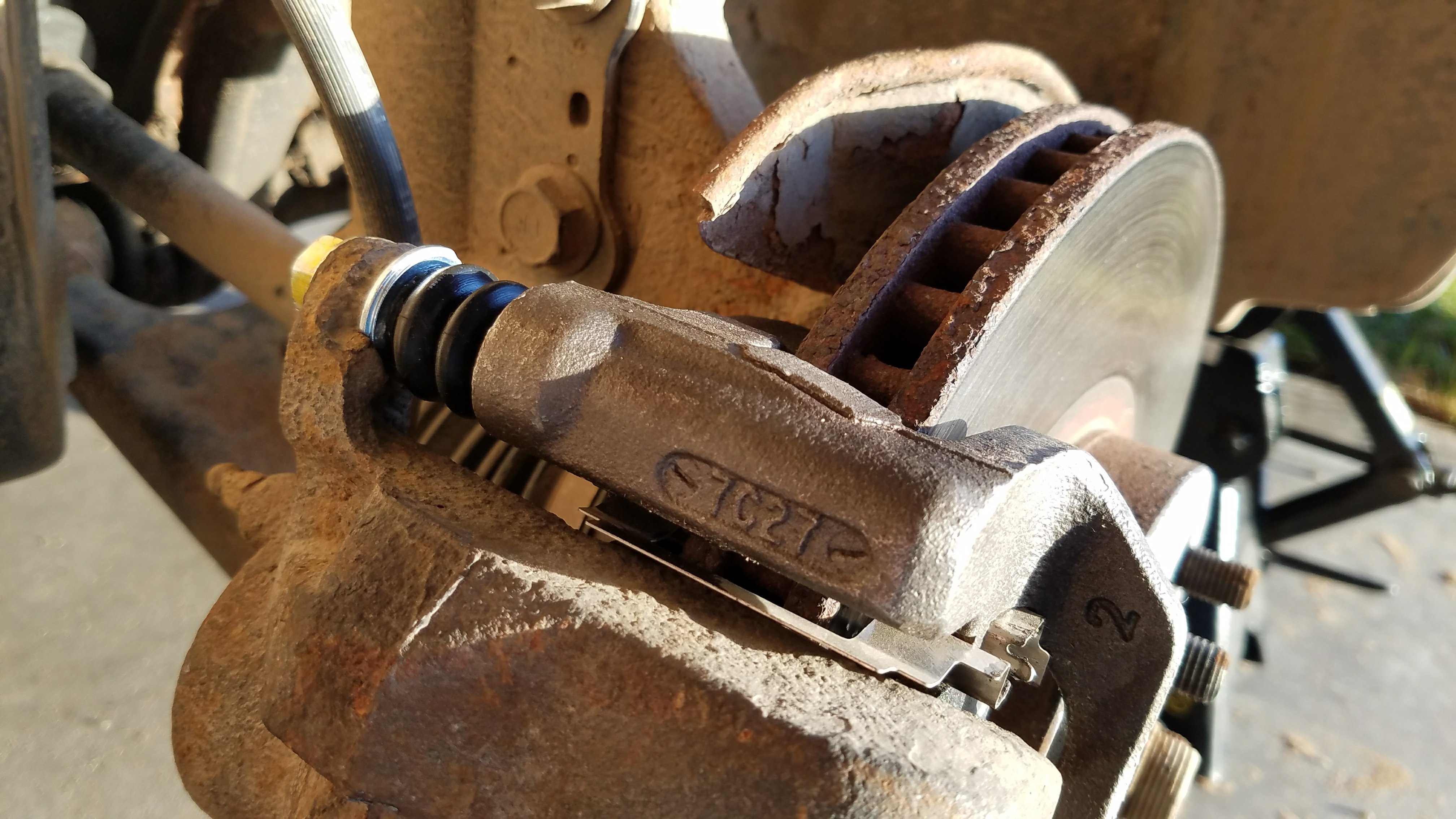 new caliper bracket and hardware installed on corolla