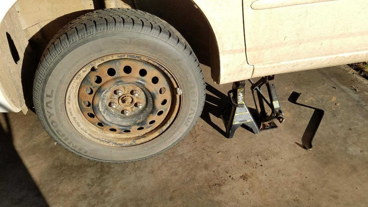 Jack up the front end of the vehicle and use a jack stand.