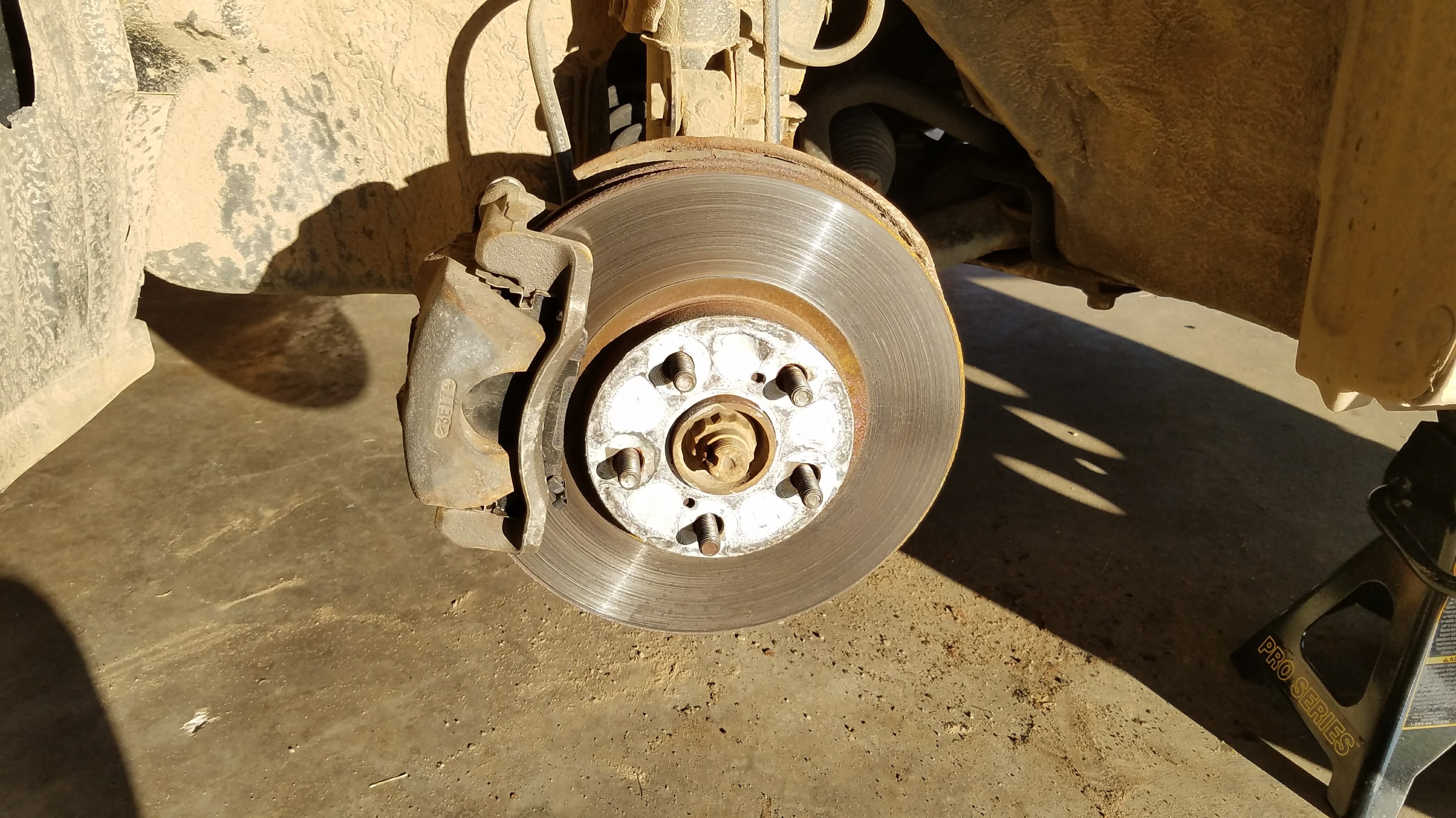 The warped rotor and brake caliper.