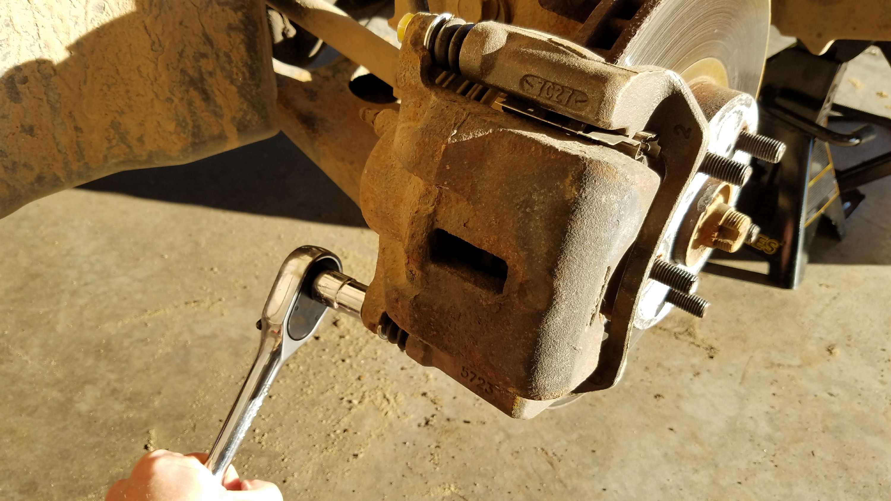 Remove the caliper mounting bolts.