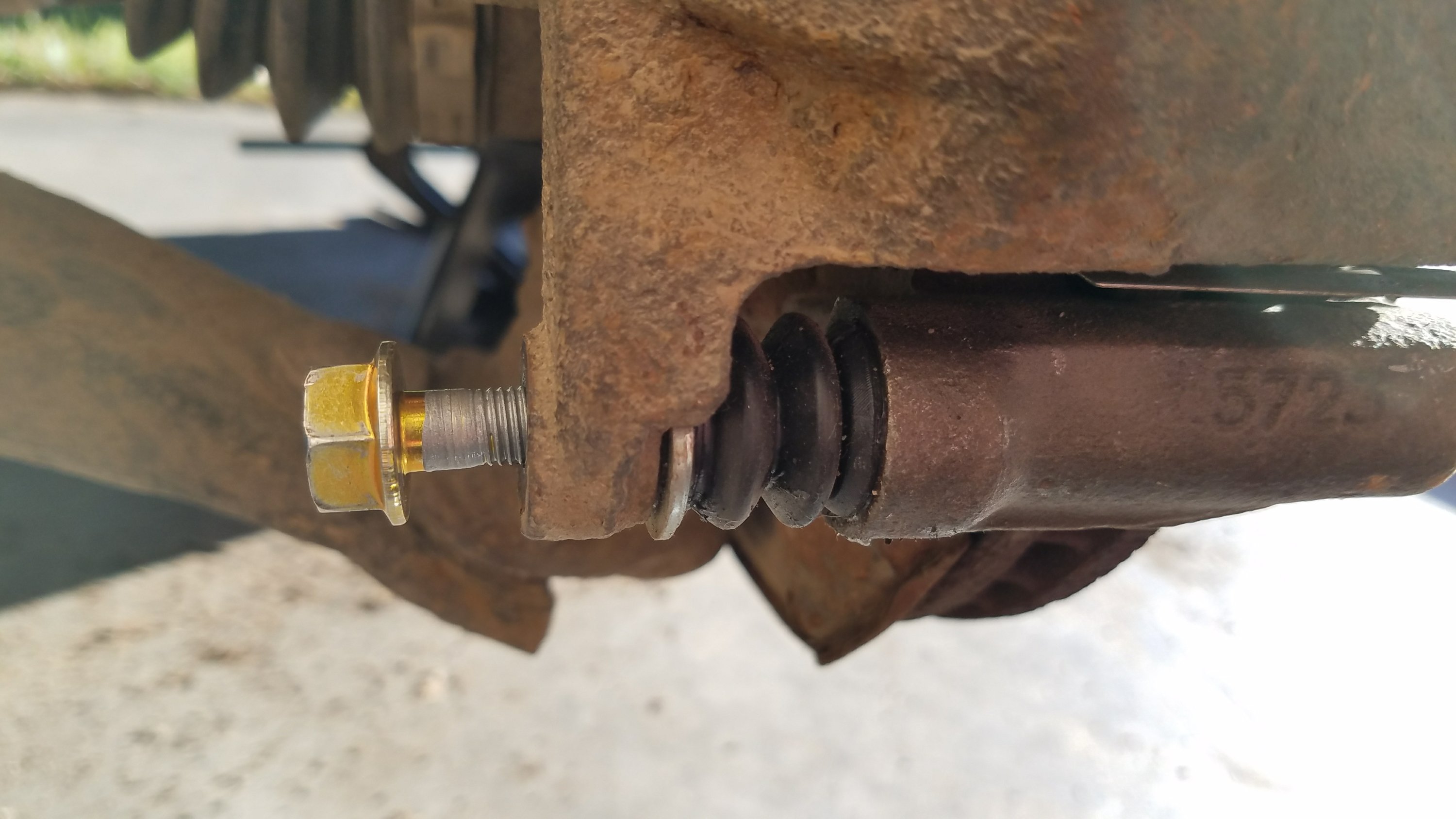 The caliper mounting bolt.
