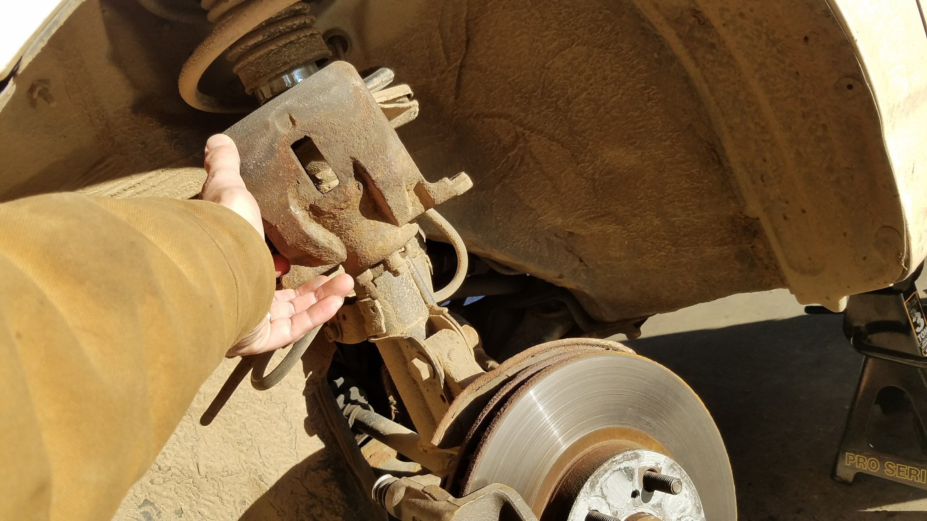 Hang the caliper from the strut.