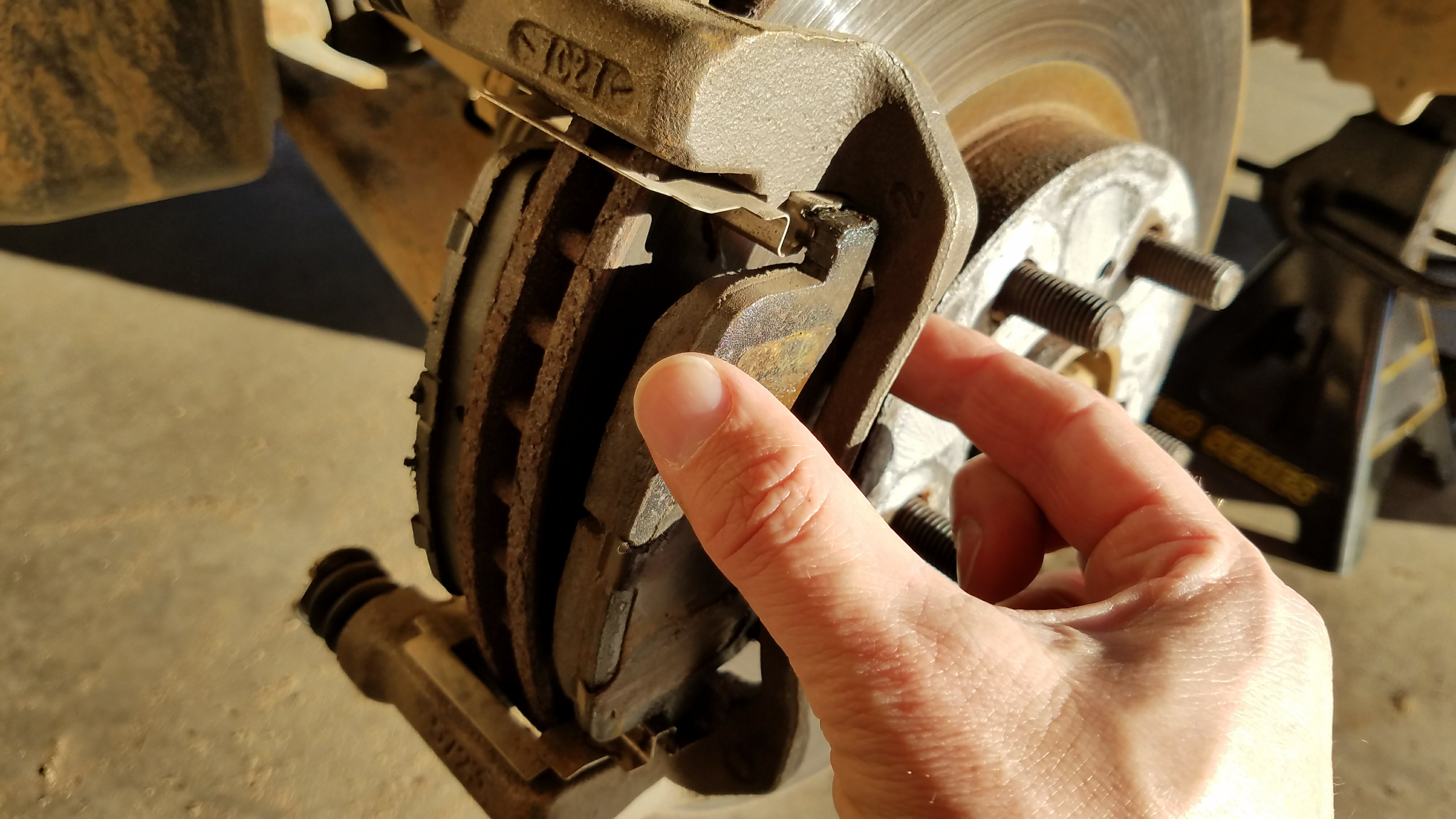Carefully remove the brake pad.