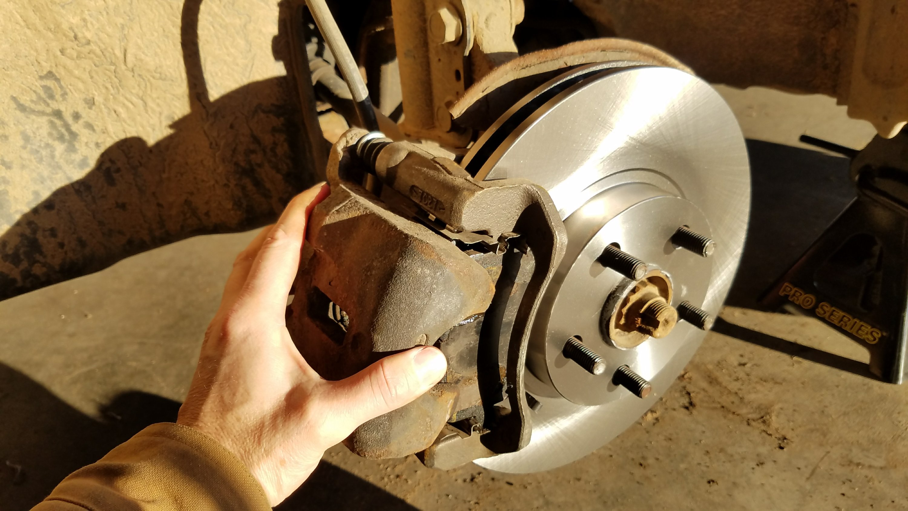 brake caliper being put onto the rotor.