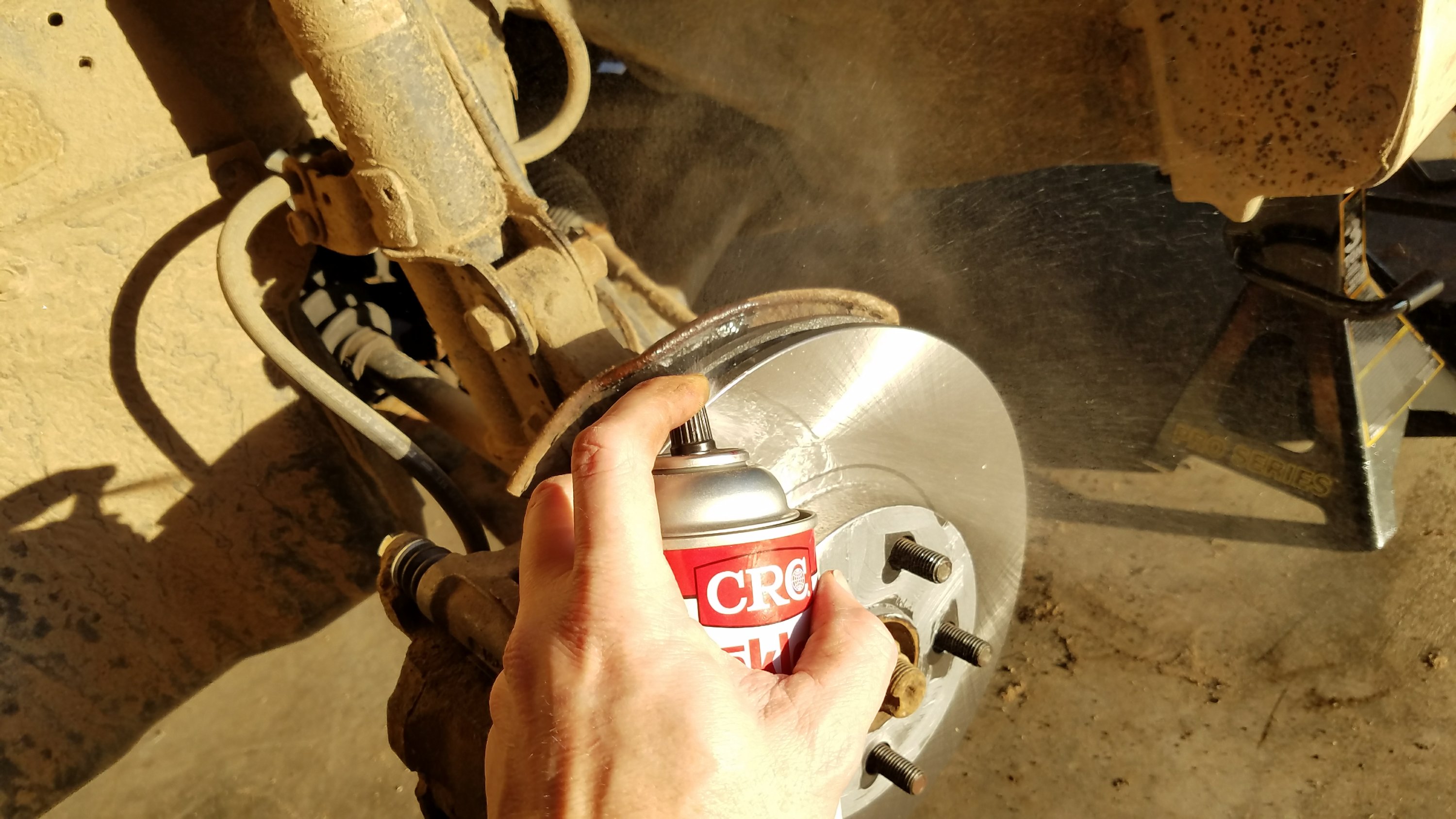 Spray brake cleaner on the rotor
