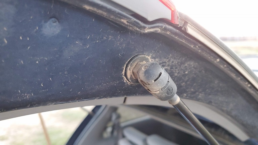 This is the old strut upper attachment point before the strut is removed. Note the location of the metal clip that will be pried out.